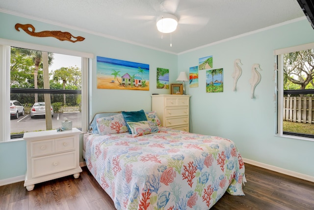 bedroom featuring ceiling fan, ornamental molding, and dark hardwood / wood-style flooring