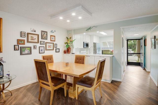 dining room featuring hardwood / wood-style floors and a textured ceiling