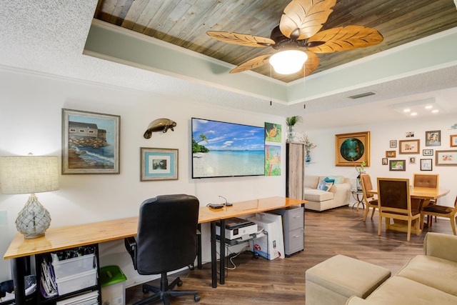 office with dark wood-type flooring, ceiling fan, wooden ceiling, a tray ceiling, and ornamental molding