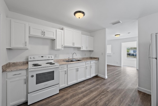 kitchen with white cabinetry, sink, white appliances, and dark hardwood / wood-style floors