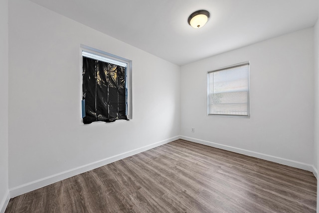 unfurnished room with hardwood / wood-style flooring