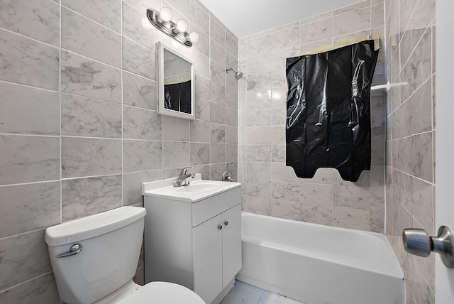 full bathroom with toilet, vanity, tile walls, and washtub / shower combination