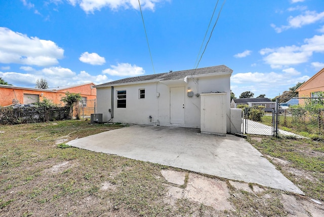 rear view of house featuring a patio area and central AC