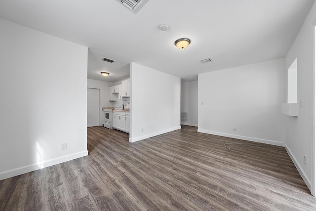 unfurnished living room with wood-type flooring