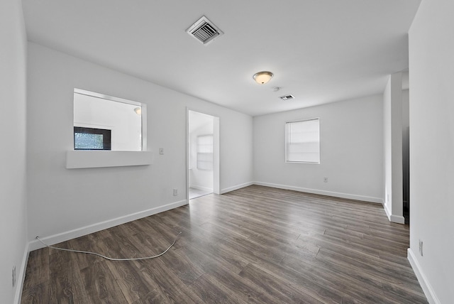 spare room featuring dark wood-type flooring