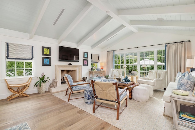 living room with light hardwood / wood-style flooring and lofted ceiling with beams