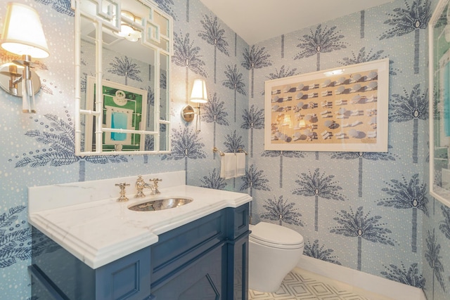 bathroom featuring toilet and vanity