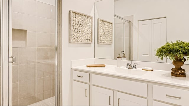 bathroom with an enclosed shower and vanity