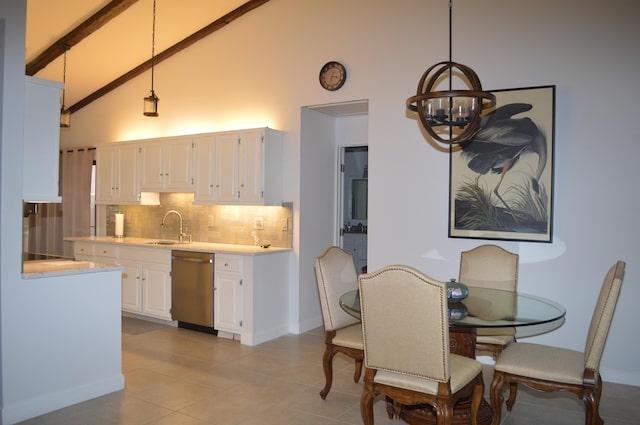 tiled dining area featuring high vaulted ceiling, sink, a chandelier, and beamed ceiling