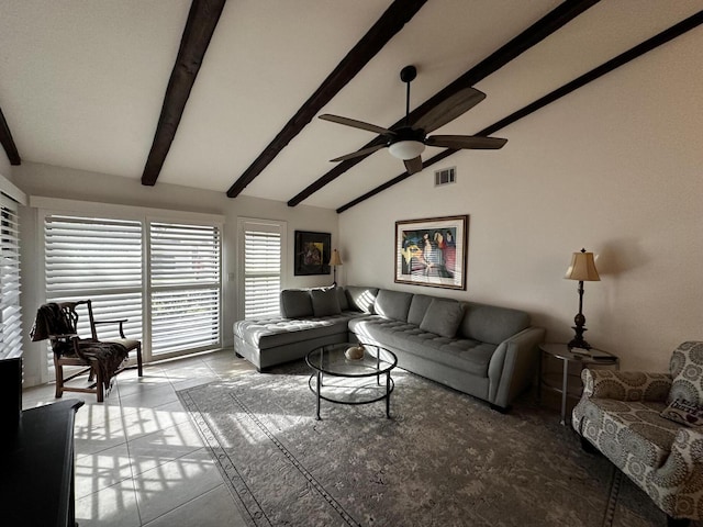 living room featuring ceiling fan, light tile patterned flooring, and vaulted ceiling with beams