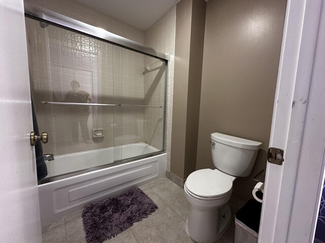 bedroom with ceiling fan and dark tile patterned floors