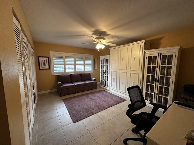 office space featuring ceiling fan and light tile patterned flooring