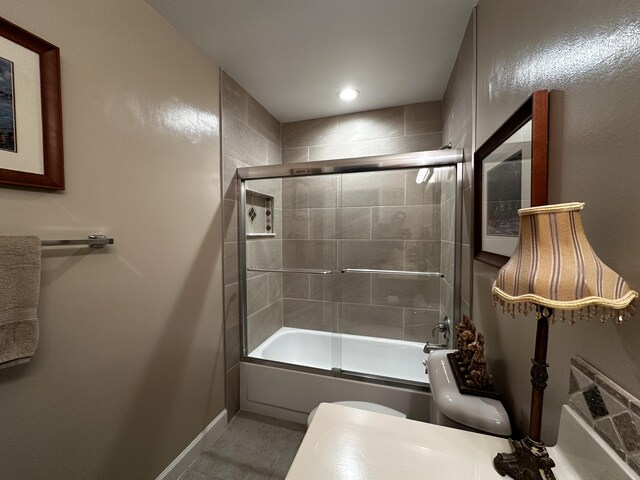 full bathroom with toilet, combined bath / shower with glass door, tile patterned floors, and vanity