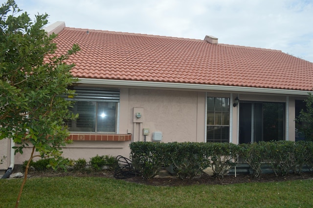 rear view of property featuring a yard