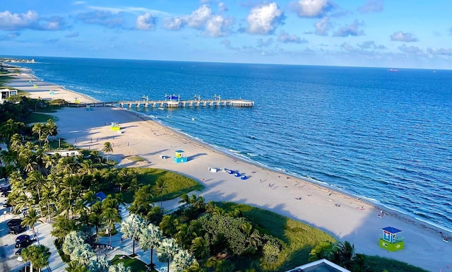 birds eye view of property featuring a water view and a beach view