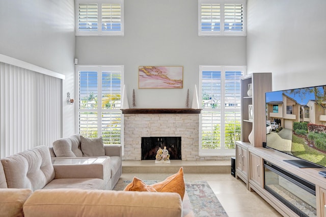 living room with a towering ceiling, a wealth of natural light, and light tile patterned flooring