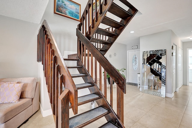 stairway with tile patterned floors