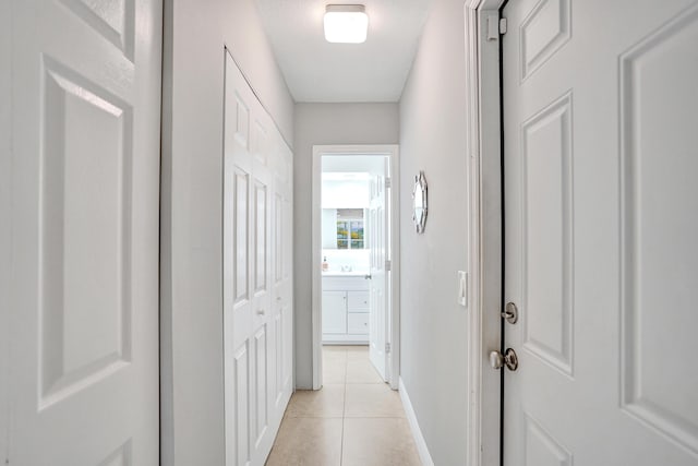 hall with light tile patterned floors