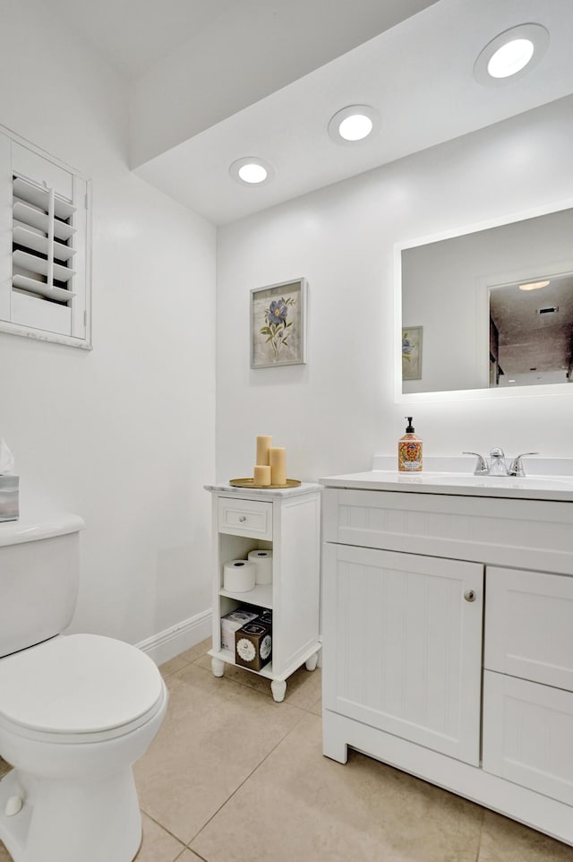 bathroom featuring vanity, tile patterned floors, and toilet