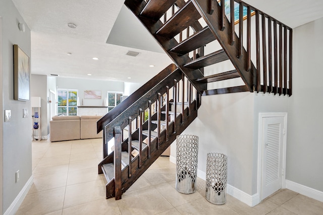 stairs with tile patterned flooring