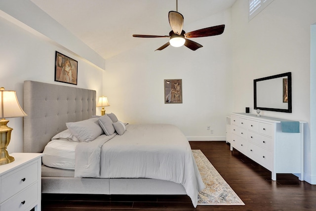 bedroom featuring ceiling fan, dark hardwood / wood-style flooring, and vaulted ceiling