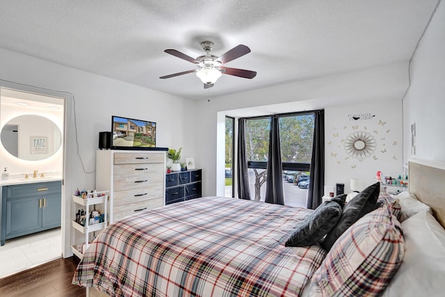 bedroom with sink, ensuite bath, a textured ceiling, dark hardwood / wood-style flooring, and ceiling fan