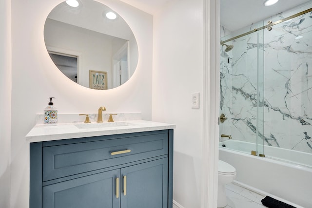 full bathroom with vanity, bath / shower combo with glass door, and toilet