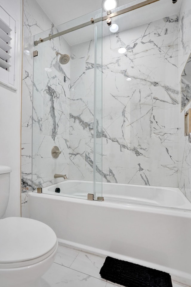 bathroom with toilet and combined bath / shower with glass door