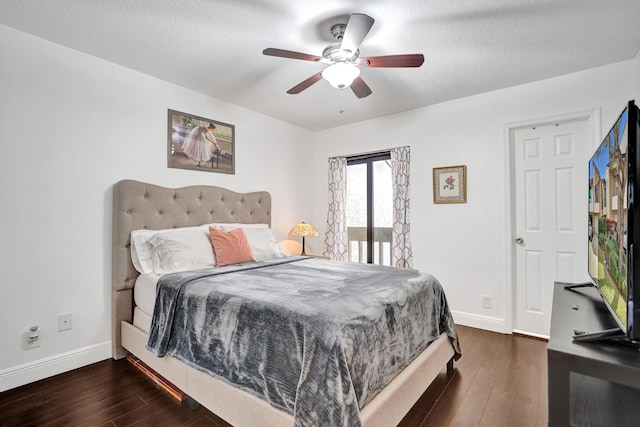 bedroom featuring ceiling fan, dark hardwood / wood-style floors, and a textured ceiling