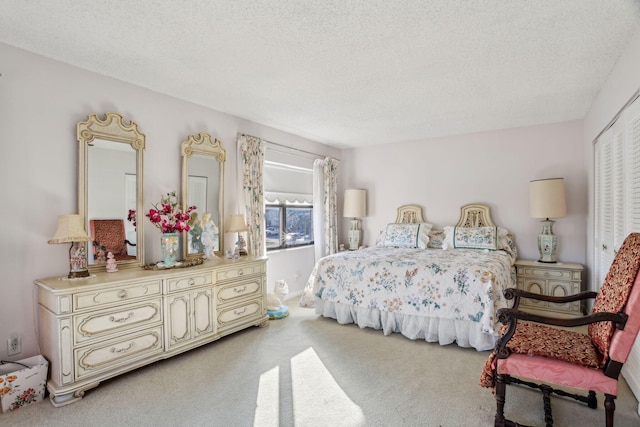 carpeted bedroom featuring a textured ceiling