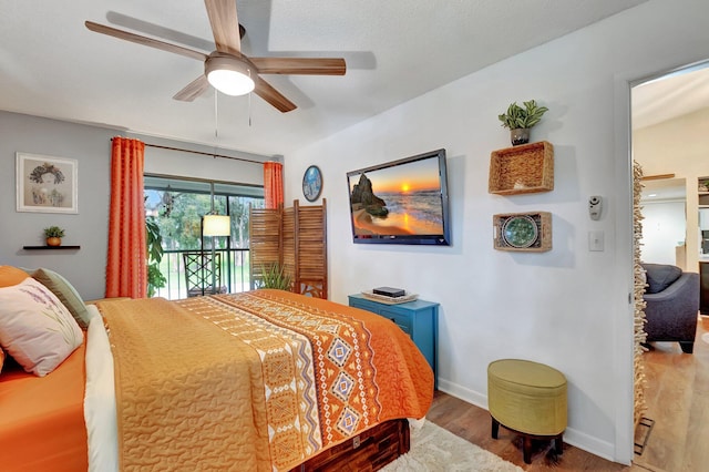 bedroom with access to exterior, wood-type flooring, and ceiling fan