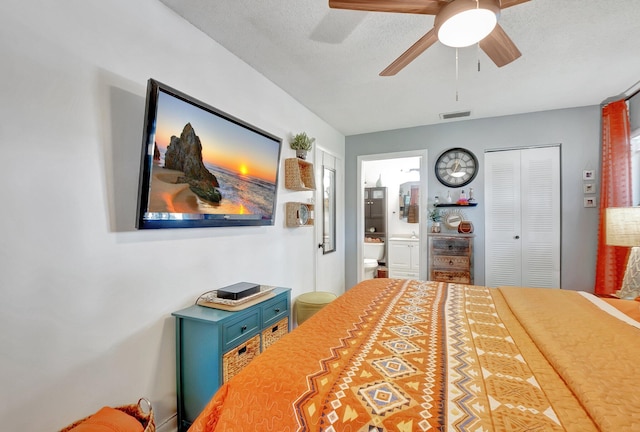 bedroom with ceiling fan, ensuite bathroom, a closet, and a textured ceiling