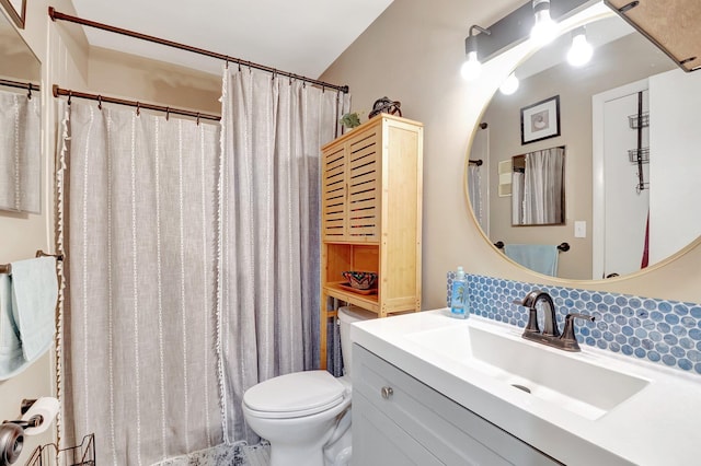 bathroom with tasteful backsplash, vanity, and toilet