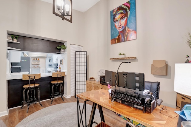 office area with hardwood / wood-style flooring and a chandelier