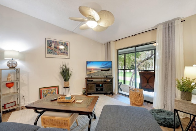 living room featuring lofted ceiling, light hardwood / wood-style floors, and ceiling fan