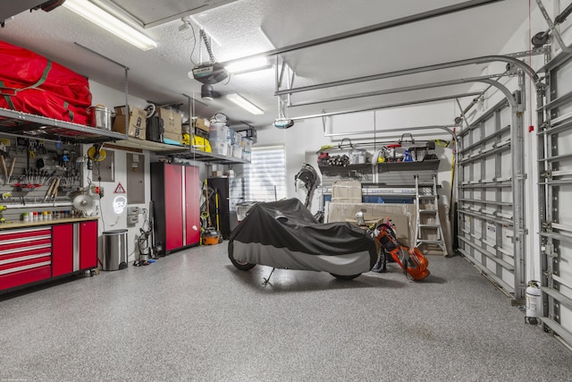 garage with a garage door opener and a workshop area