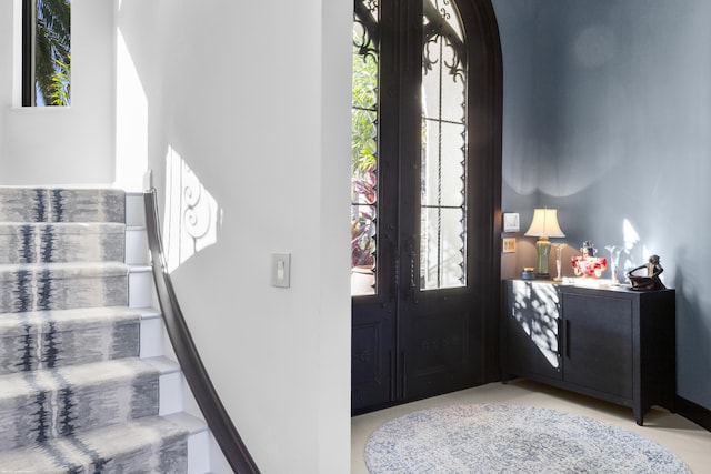 foyer featuring french doors and a wealth of natural light