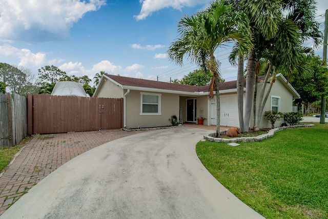 single story home featuring a front yard and a garage