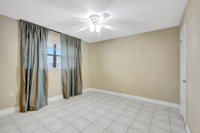 unfurnished room with ceiling fan and light tile patterned floors