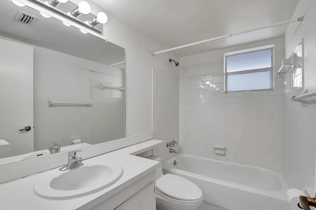 full bathroom with toilet, vanity, and tiled shower / bath combo