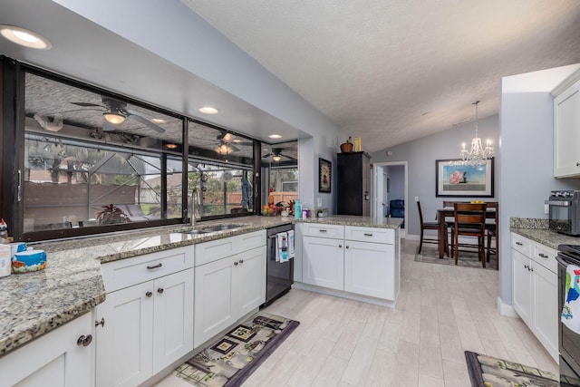 kitchen with sink, vaulted ceiling, white cabinets, and kitchen peninsula