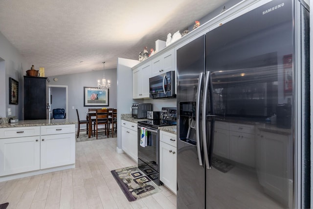 kitchen featuring pendant lighting, white cabinetry, black range with electric cooktop, vaulted ceiling, and fridge with ice dispenser