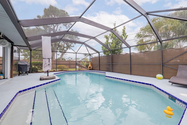 view of swimming pool featuring glass enclosure, a patio area, and area for grilling