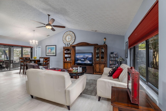 living room featuring ceiling fan with notable chandelier, a textured ceiling, light hardwood / wood-style flooring, and vaulted ceiling