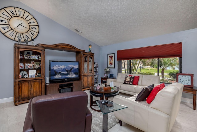 living room featuring light hardwood / wood-style floors, a textured ceiling, and vaulted ceiling