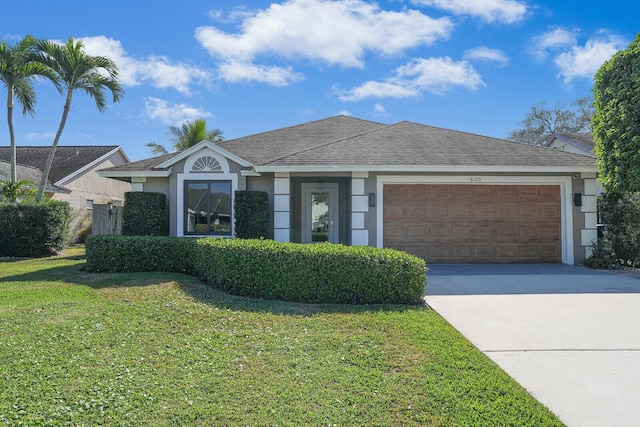 single story home featuring a front lawn and a garage