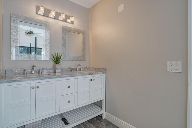 bathroom featuring ceiling fan, vanity, and wood-type flooring