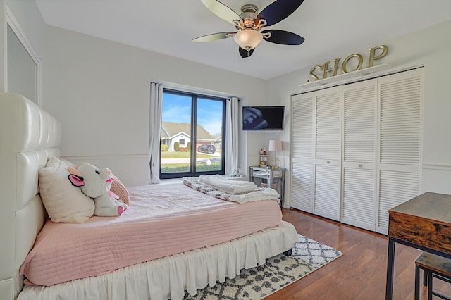 bedroom featuring ceiling fan, a closet, and dark hardwood / wood-style flooring