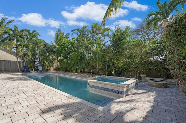 view of swimming pool with an in ground hot tub and a patio area