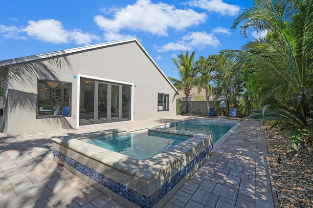 view of swimming pool with a patio and an in ground hot tub